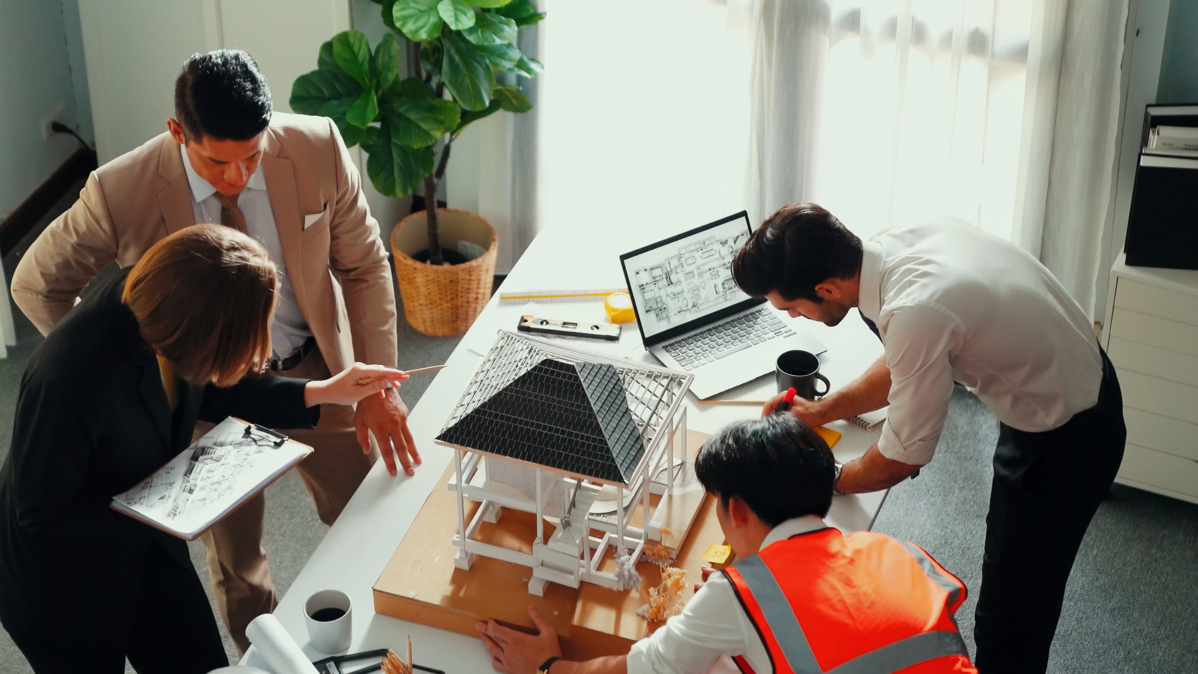 Manufacturing and engineering team reviewing a production model